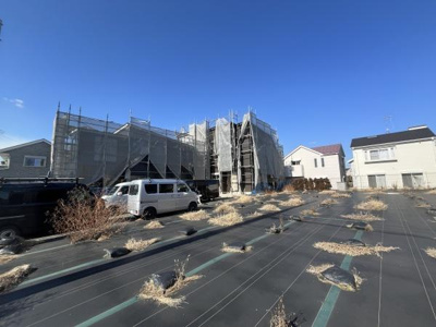 建築中の物件がしっかりと足場で覆われており施工が着実に進められています。敷地内は広く車両の駐車スペースも十分に確保されています。周囲には住宅が立ち並び落ち着いた環境が感じられます。