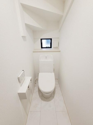 白を基調としたトイレ空間はすっきりとした印象を与えます。小窓が設けられているため換気も期待できます。シンプルなデザインで清潔感があります。操作パネルが壁付けで使いやすい配置です。