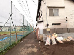 前面道路は舗装されており歩行しやすい道幅となっています。近隣にはフェンス付きのグラウンドがあり周囲に視界が開けています。建物の外観も現地写真からしっかり確認できます。