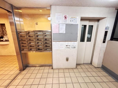 エントランスにはメールボックスとエレベーターが配置されており室内への移動も快適です。清潔感のあるタイル張りの空間で管理状況も掲示板から確認できます。明るい照明が設置され使いやすい設備が整っています。