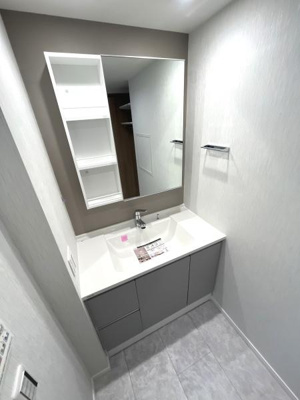 明るく清潔感のある洗面台は広いミラーが特徴です。収納棚も設けられており整理整頓もしやすい設計です。シンプルで使いやすい空間が魅力です。床はお手入れのしやすい素材となっています。